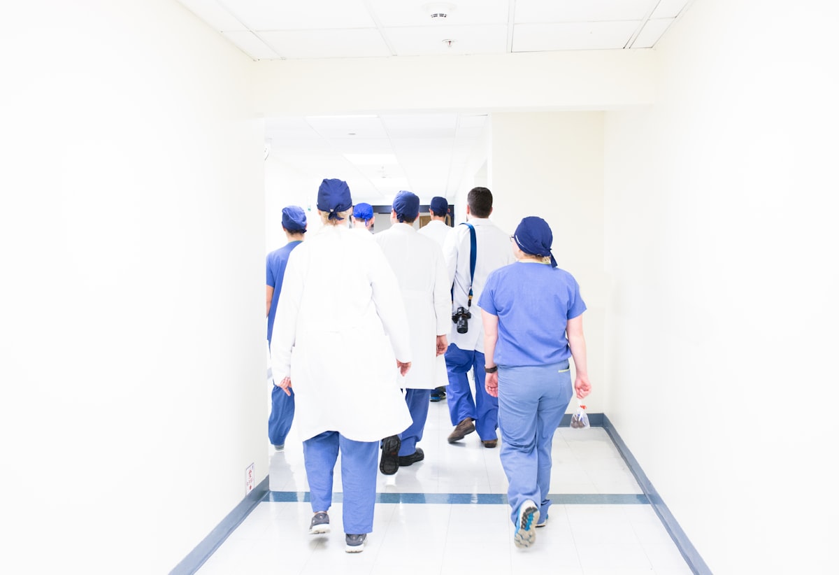 Medical team walking through a bright hospital corridor