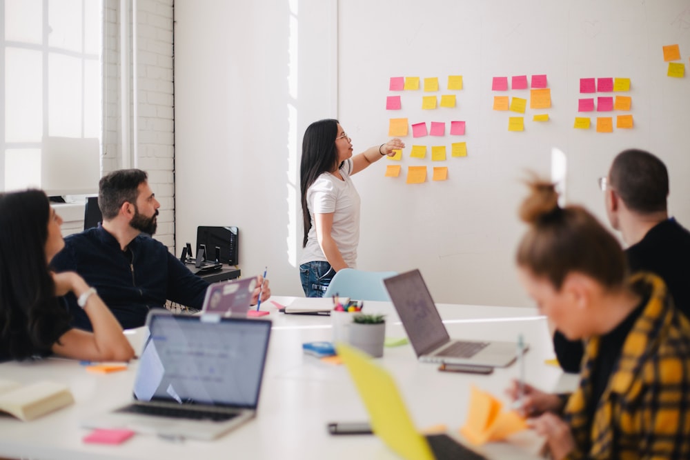 Team brainstorming campaign ideas together in a bright shared workspace
